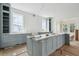 Spacious kitchen featuring custom cabinets, marble countertops, and large windows, flooded with natural light at 545 Towles Crossing Dr # 29455, Johns Island, SC 29455
