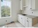 White cabinets provide a bright and clean look with stone countertops and a window view at 545 Towles Crossing Dr # 29455, Johns Island, SC 29455