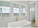 Luxurious bathroom with tub, windows, and marsh view at 546 Towles Crossing Dr, Johns Island, SC 29455