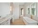 Luxury bathroom with double sinks, marble countertop, soaking tub and elegant gold fixtures at 546 Towles Crossing Dr, Johns Island, SC 29455