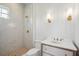 Elegant bathroom featuring a tiled shower with gold fixtures, vanity with marble countertop and wood cabinets at 546 Towles Crossing Dr, Johns Island, SC 29455