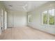 Bright bedroom featuring light green walls, wood floors, and two large windows at 546 Towles Crossing Dr, Johns Island, SC 29455