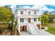 Beautiful waterfront home with a spacious front porch, staircase, and ground level garage at 546 Towles Crossing Dr, Johns Island, SC 29455