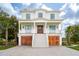 Elegant home with inviting staircase, lovely landscaping, and ground-level garage at 546 Towles Crossing Dr, Johns Island, SC 29455