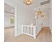 Bright hallway featuring white wainscoting, wood floors, and decorative lighting at 546 Towles Crossing Dr, Johns Island, SC 29455
