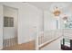 Bright hallway with white wainscoting, wood floors, and decorative lighting at 546 Towles Crossing Dr, Johns Island, SC 29455