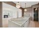 Kitchen island featuring marble countertops and gold fixtures open to a living area with fireplace at 546 Towles Crossing Dr, Johns Island, SC 29455