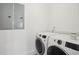 Bright laundry room with modern, front-loading washer and dryer at 546 Towles Crossing Dr, Johns Island, SC 29455