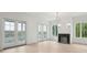 Bright living room with fireplace, doors leading to outdoor balcony, and light wood floors at 546 Towles Crossing Dr, Johns Island, SC 29455