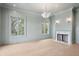 Spacious living room with fireplace, ample natural light and light wood floors at 546 Towles Crossing Dr, Johns Island, SC 29455