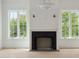 Stylish living room with fireplace, ample natural light and light wood floors at 546 Towles Crossing Dr, Johns Island, SC 29455