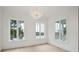 Bright living room featuring hardwood floors, large windows, and designer lighting at 546 Towles Crossing Dr, Johns Island, SC 29455