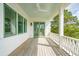 Charming covered porch featuring green door and window frames at 546 Towles Crossing Dr, Johns Island, SC 29455