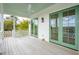 Enjoy outdoor living on this porch featuring green doors, white railings, and a ceiling fan at 546 Towles Crossing Dr, Johns Island, SC 29455