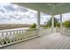 Spacious porch boasts white columns, a ceiling fan, and panoramic views of the marsh at 546 Towles Crossing Dr, Johns Island, SC 29455