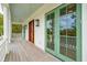 The spacious porch with wood flooring, ceiling fan, lighting, and views of the nearby trees at 546 Towles Crossing Dr, Johns Island, SC 29455