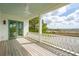 Inviting covered porch with wooden floors offering scenic water views at 546 Towles Crossing Dr, Johns Island, SC 29455