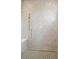 Luxurious shower with gold shower head, white tiles, green and white mosaic tiles, and a corner bench at 546 Towles Crossing Dr, Johns Island, SC 29455