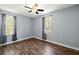 Bedroom featuring hardwood floors, neutral colored walls, a ceiling fan, and two windows at 63 Guerry Cir, Goose Creek, SC 29445
