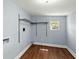 Practical laundry room featuring hardwood floors, a window, and shelving at 63 Guerry Cir, Goose Creek, SC 29445