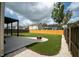 Spacious backyard features artificial turf, a patio, and a fire pit, perfect for outdoor entertaining and relaxation at 7638 Haywood St, North Charleston, SC 29418