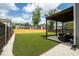 This spacious backyard features a manicured lawn, a patio with seating, and a privacy fence at 7638 Haywood St, North Charleston, SC 29418