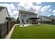 Spacious backyard features a manicured lawn, a patio with seating, and a well-maintained fence at 7638 Haywood St, North Charleston, SC 29418
