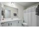Bright bathroom featuring a shower with curtain, a large mirror, and a vanity with plenty of storage at 7638 Haywood St, North Charleston, SC 29418