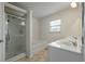 Bright bathroom with separate shower and tub, and dual sinks at 7638 Haywood St, North Charleston, SC 29418