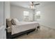 This bedroom features neutral walls, soft carpet, a ceiling fan, and a window with natural light at 7638 Haywood St, North Charleston, SC 29418