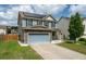 Two-story home featuring solar panels, a stone facade, and a driveway leading to an attached garage at 7638 Haywood St, North Charleston, SC 29418
