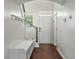 Inviting foyer with hardwood floors, a coat rack, and natural light from a window at 7638 Haywood St, North Charleston, SC 29418
