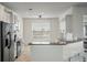Galley kitchen featuring white cabinets, stainless steel appliances, and granite countertops at 7638 Haywood St, North Charleston, SC 29418