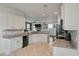 Open-concept kitchen with granite countertops, tile backsplash, and stainless steel appliances at 7638 Haywood St, North Charleston, SC 29418