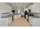 Well-lit kitchen with white cabinets, stainless steel appliances, and a tile backsplash at 7638 Haywood St, North Charleston, SC 29418