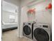 Convenient laundry room adjacent to bedroom includes modern washer and dryer and shelving storage at 7638 Haywood St, North Charleston, SC 29418