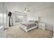 Bright main bedroom featuring a ceiling fan, tray ceiling, and plush carpeting at 7638 Haywood St, North Charleston, SC 29418
