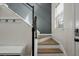 Staircase featuring natural wood steps, metal railing and a coat rack at 7638 Haywood St, North Charleston, SC 29418