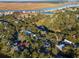 An aerial view captures the community featuring lush trees, beautiful waterfront views, and a golf course at 764 Summerwind Cir, Edisto Beach, SC 29438