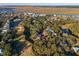 Gorgeous aerial view of homes surrounded by trees, along a waterfront and a golf course, showcasing community and natural beauty at 764 Summerwind Cir, Edisto Beach, SC 29438