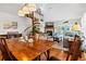 Charming dining area adjacent to the living room with a spiral staircase at 764 Summerwind Cir, Edisto Beach, SC 29438