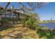 Beautiful home exterior with lagoon view and lush greenery on a sunny day with blue skies at 764 Summerwind Cir, Edisto Beach, SC 29438