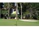 A lush green golf course view with a sand trap and a home in the background at 764 Summerwind Cir, Edisto Beach, SC 29438