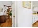 Hallway view with wood floors leading to spiral staircase and kitchen at 764 Summerwind Cir, Edisto Beach, SC 29438