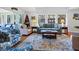 Bright living room with large windows, a comfortable blue sofa, and nautical decor providing a relaxing atmosphere at 764 Summerwind Cir, Edisto Beach, SC 29438