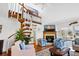 Cozy living room with spiral staircase, fireplace, and comfortable arm chairs at 764 Summerwind Cir, Edisto Beach, SC 29438