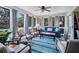 Inviting sun room with large windows, plush seating, and a stylish blue area rug at 764 Summerwind Cir, Edisto Beach, SC 29438