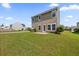 Expansive backyard with lush green grass, patio, and mature landscaping at 9652 Spencer Woods Rd, Ladson, SC 29456