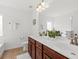 Bright bathroom featuring double sinks, wood cabinets, white countertops, and modern lighting at 9652 Spencer Woods Rd, Ladson, SC 29456