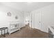 Open bedroom with a changing table and view of the hallway at 9652 Spencer Woods Rd, Ladson, SC 29456